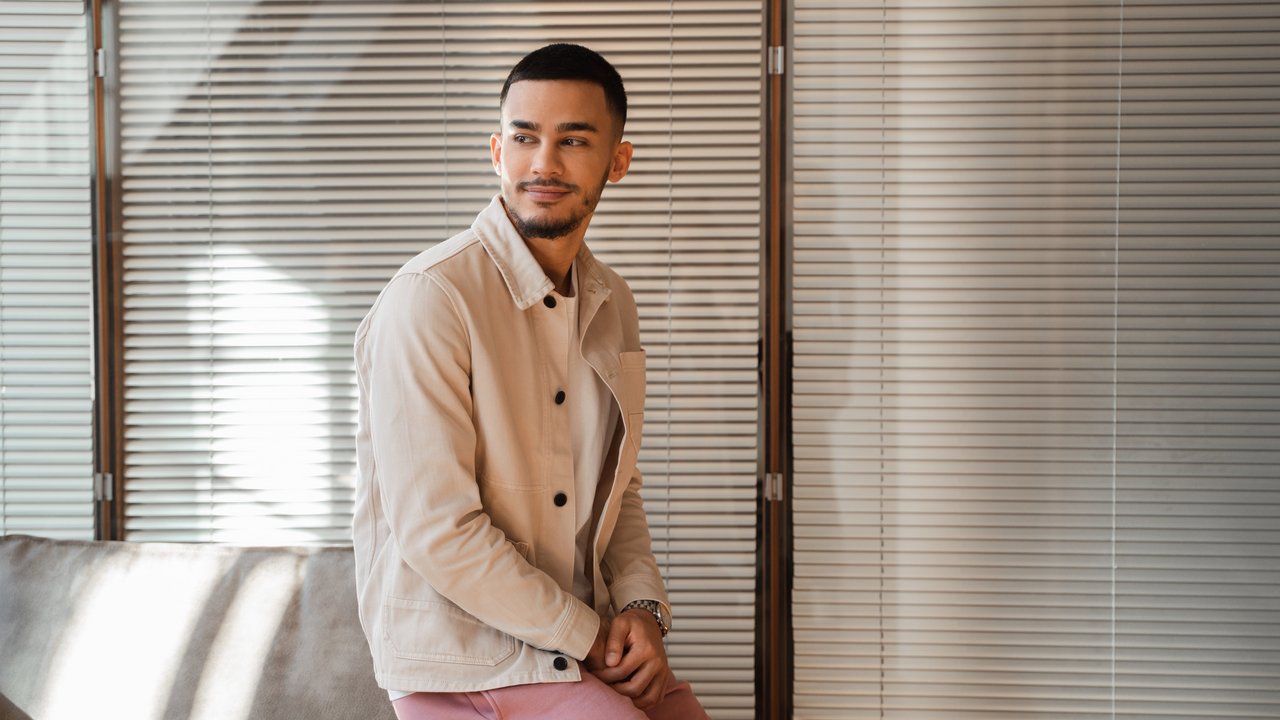 Young man sitting indoors.
